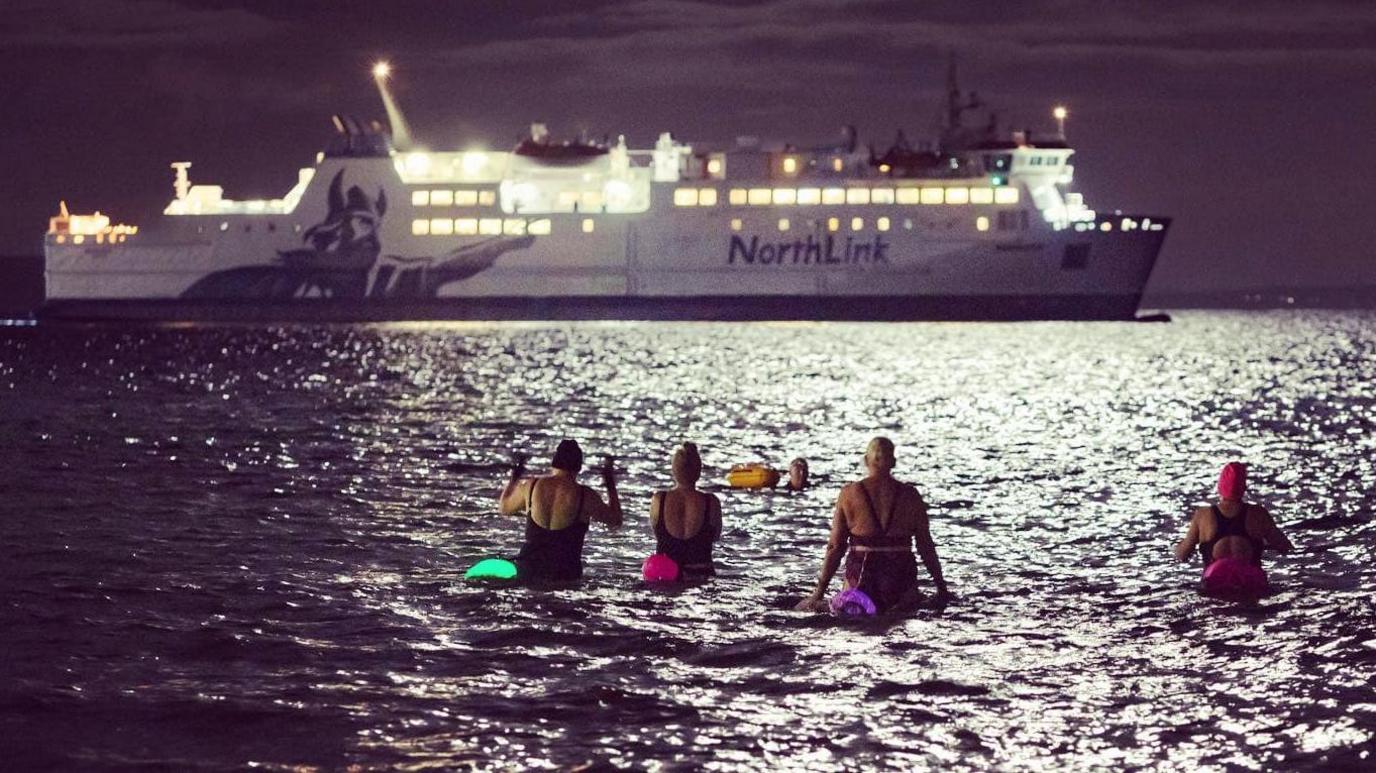 Swimmers and ferry