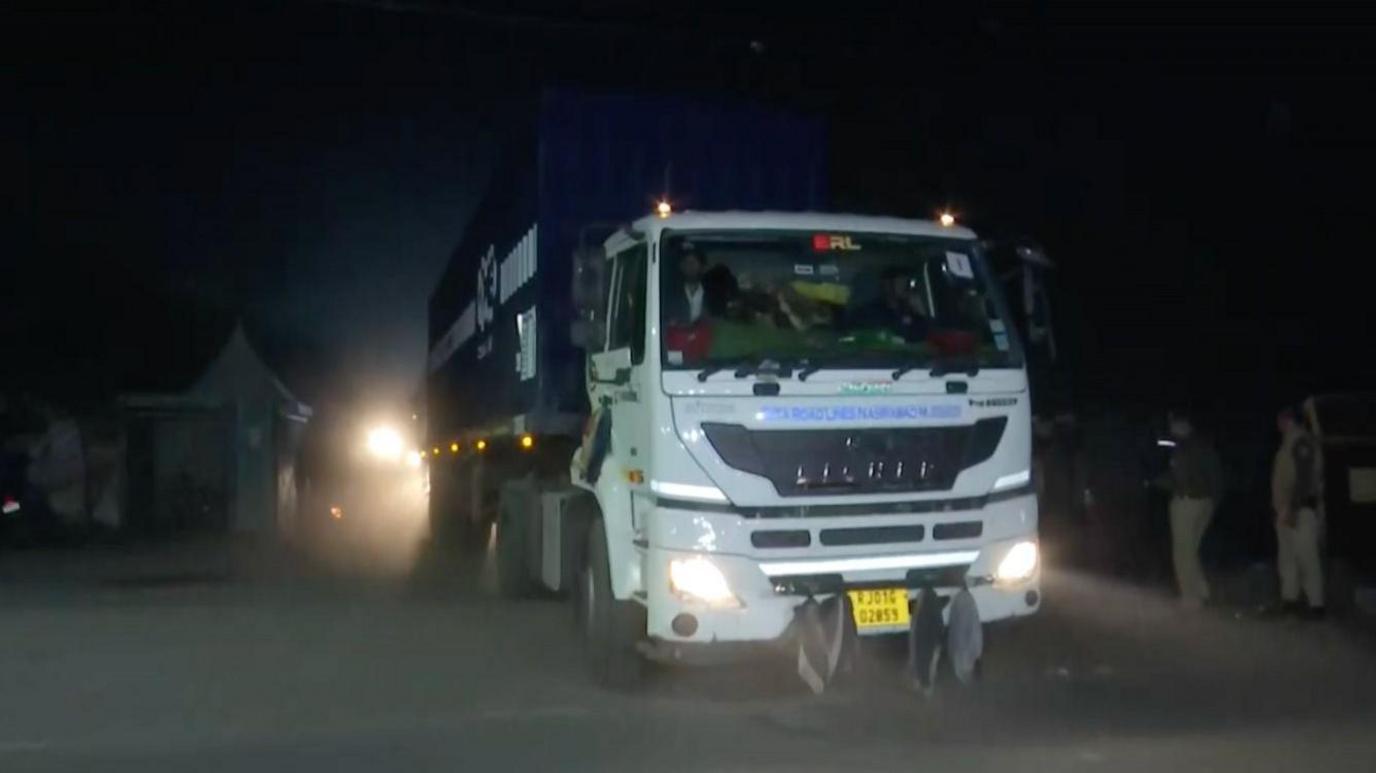 A container truck carrying toxic waste from Bhopal city with police men present 