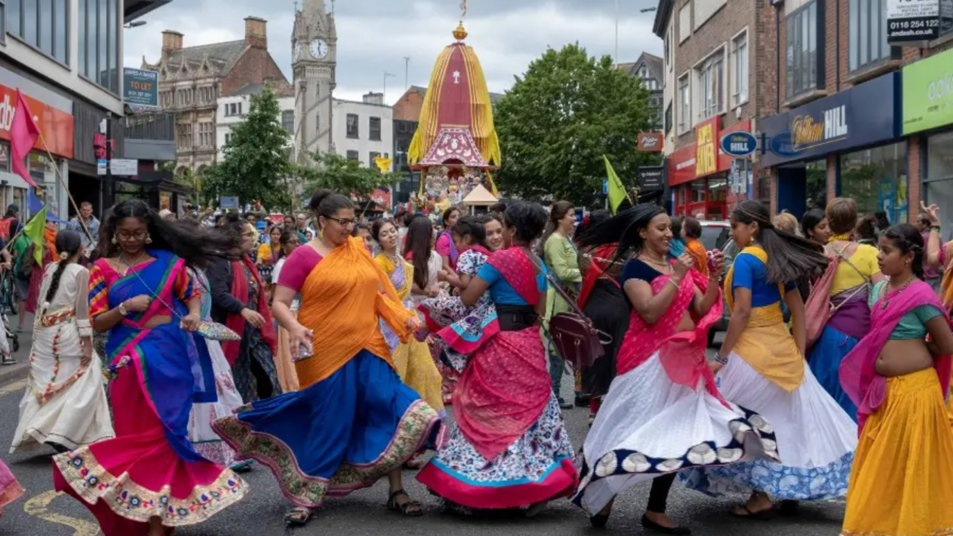 A previous Festival of Chariots event in Leicester with a group of people dancing with brightly-coloured clothes