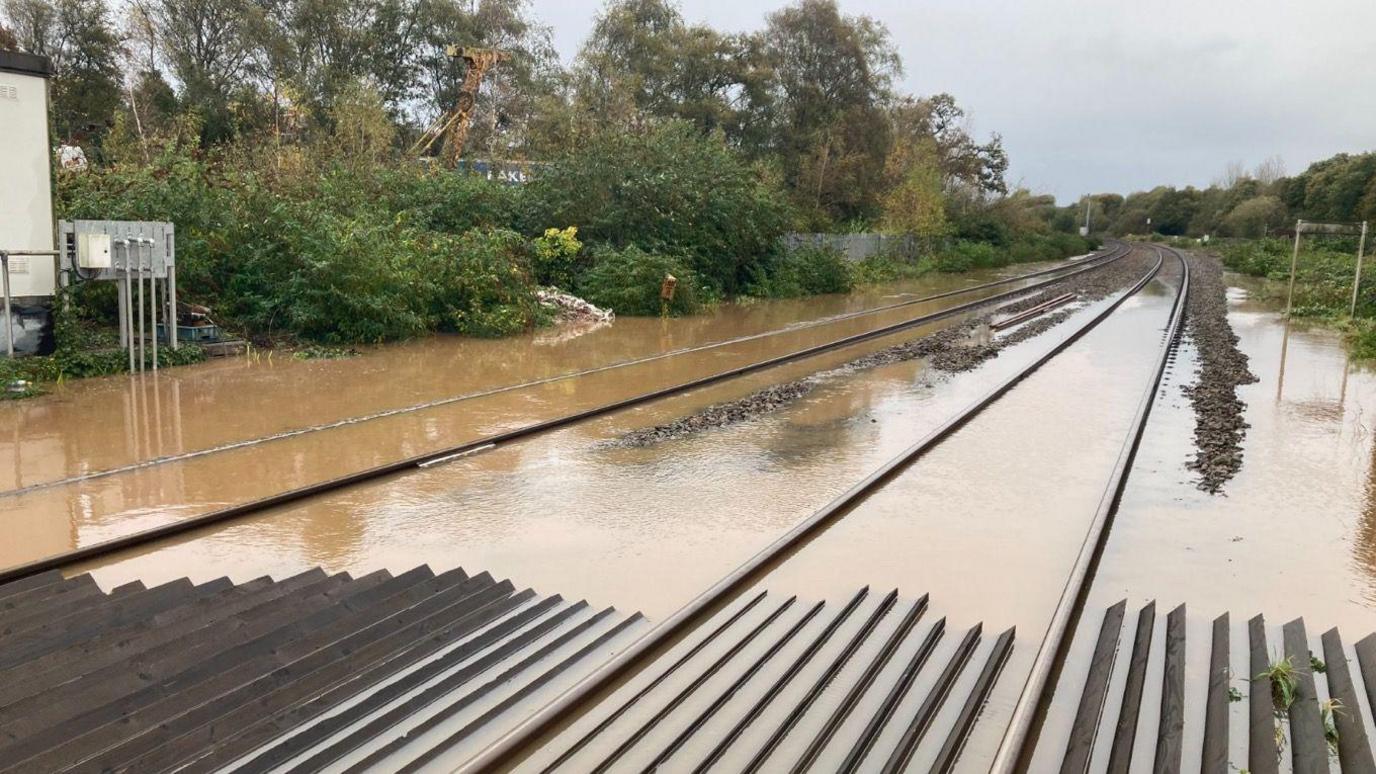 View of flooded rahttps://optimo.tools.bbc.co.uk/_activities/imageUpload/image?locator=6486%2Flive%2Fe53b2af0-7987-11ee-934c-573ebeccef5c.jpg&bucket=cps-images-private-liveilway line