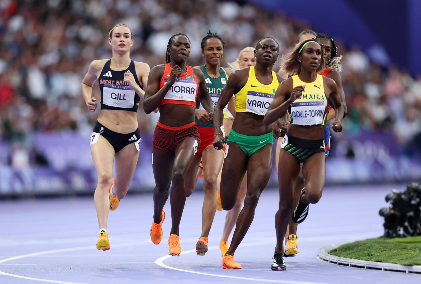 Phoebe Gill, in a Team GB running kit, taking the bend during the 800m 