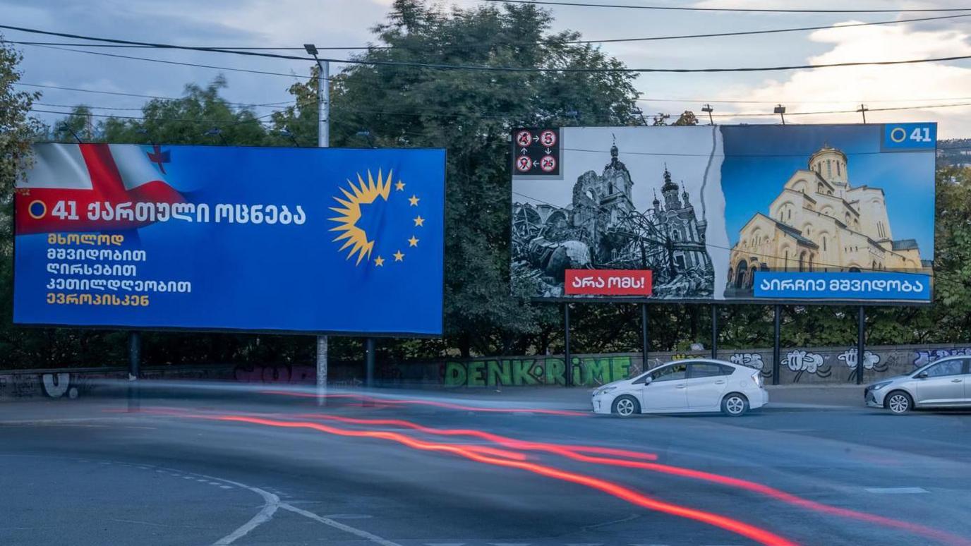 A billboard in Tbilisi compares the war in Ukraine to the peace in Georgia