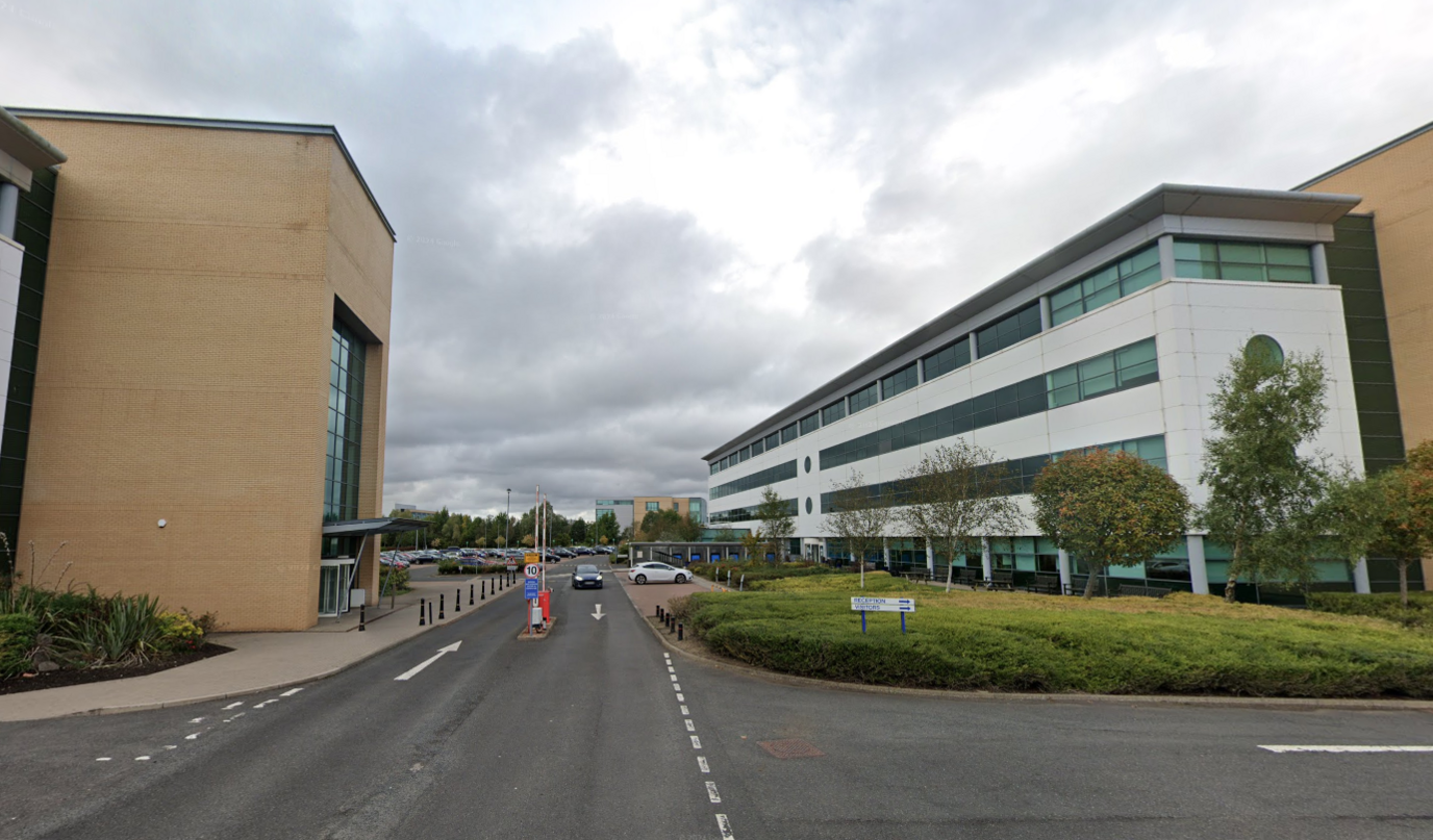 Gloomy cloudy day at an business park with cars on the road