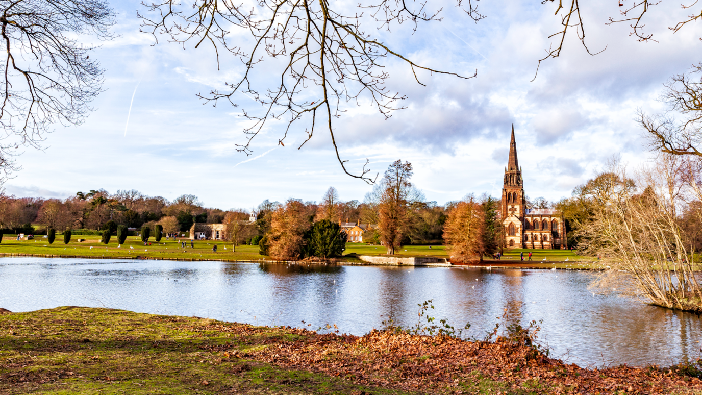 A general view of Clumber Park in Nottinghamshire taken in front of a lake with a chapel on the other side