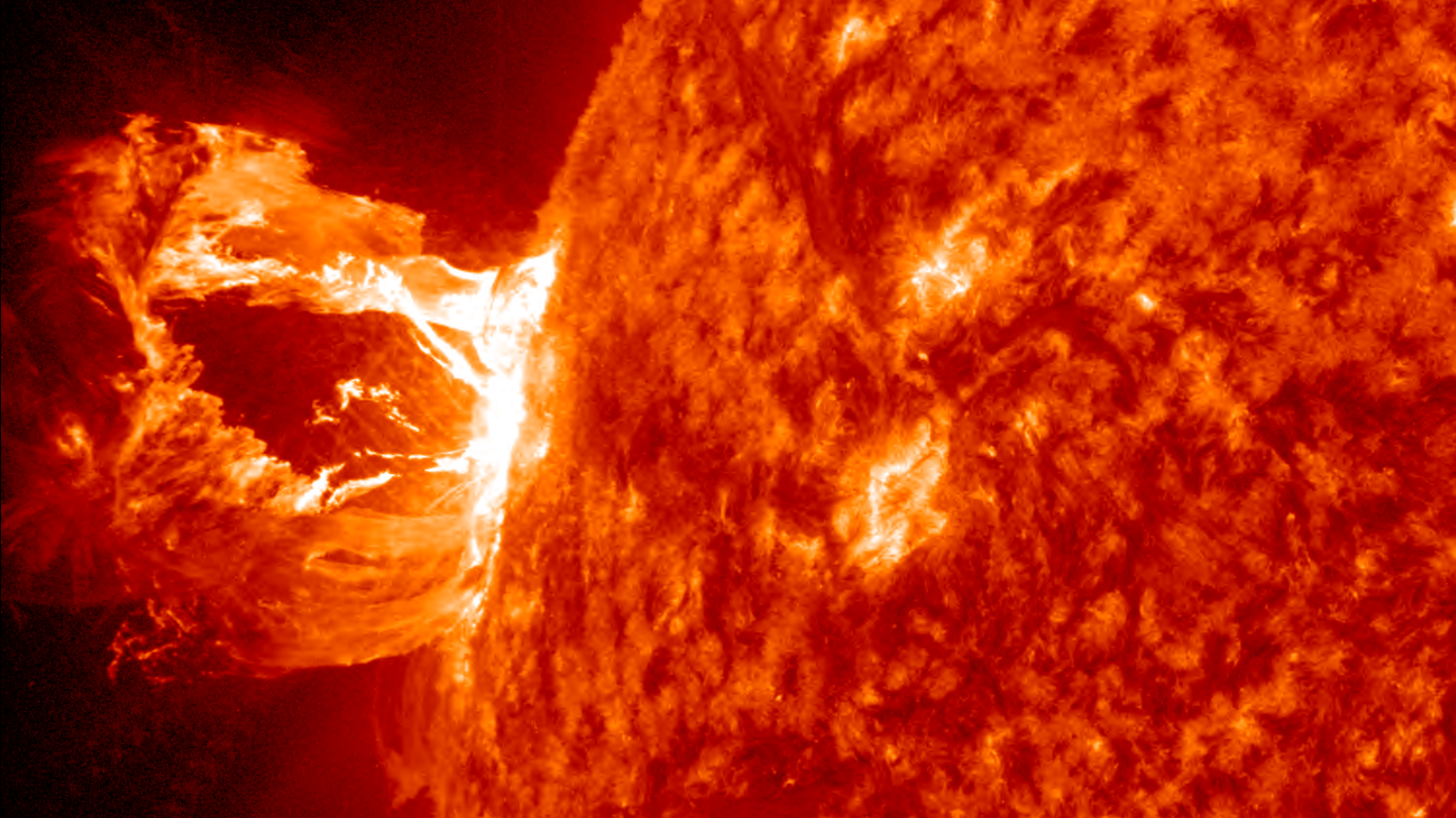 Image of solar flare from Nasa's Solar Dynamics Observatory. The flare appears as vivid red and orange.