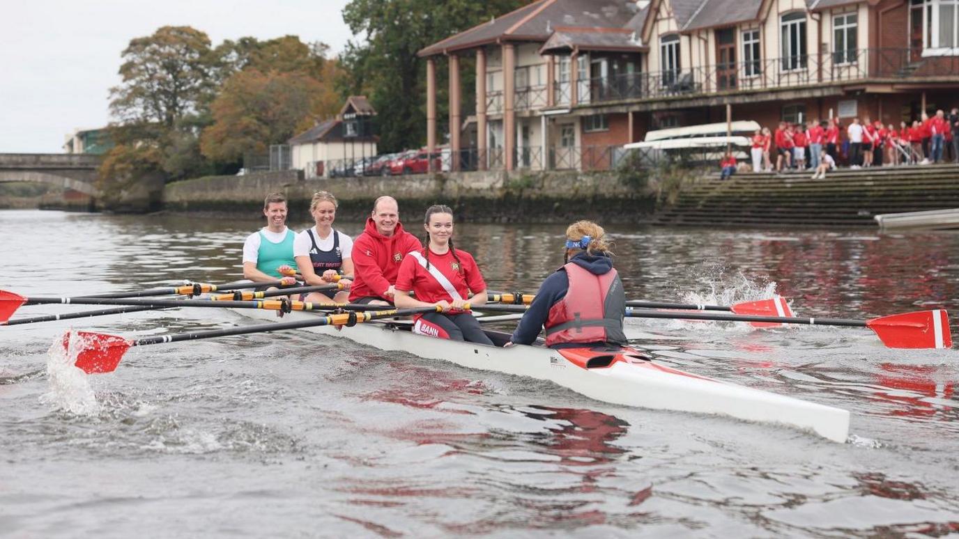 Communities Minister Gordon Lyons (third from left) joined Hannah Scott on the River Bann