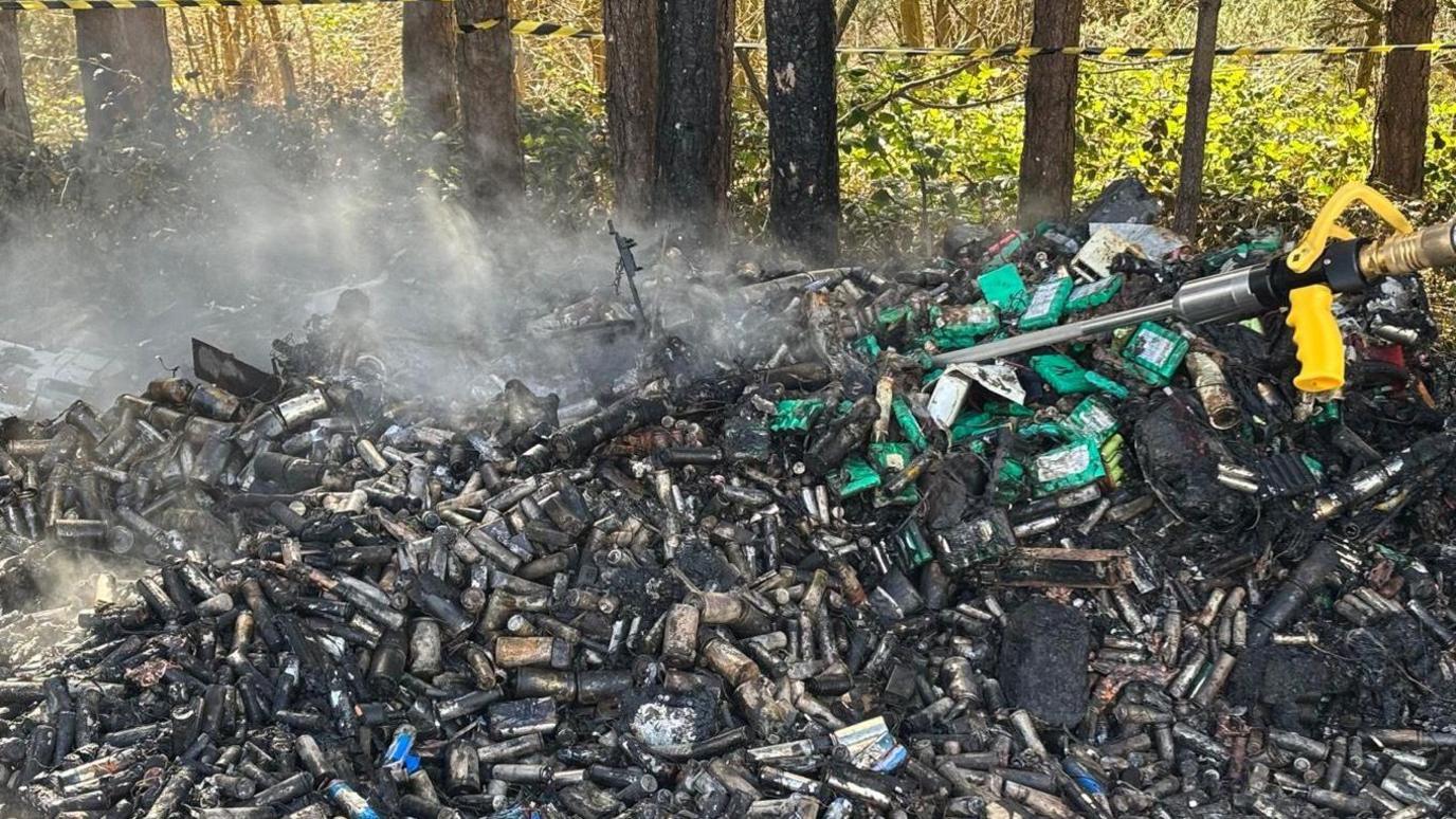 A close-up of a pile of scorched lithium-ion batteries