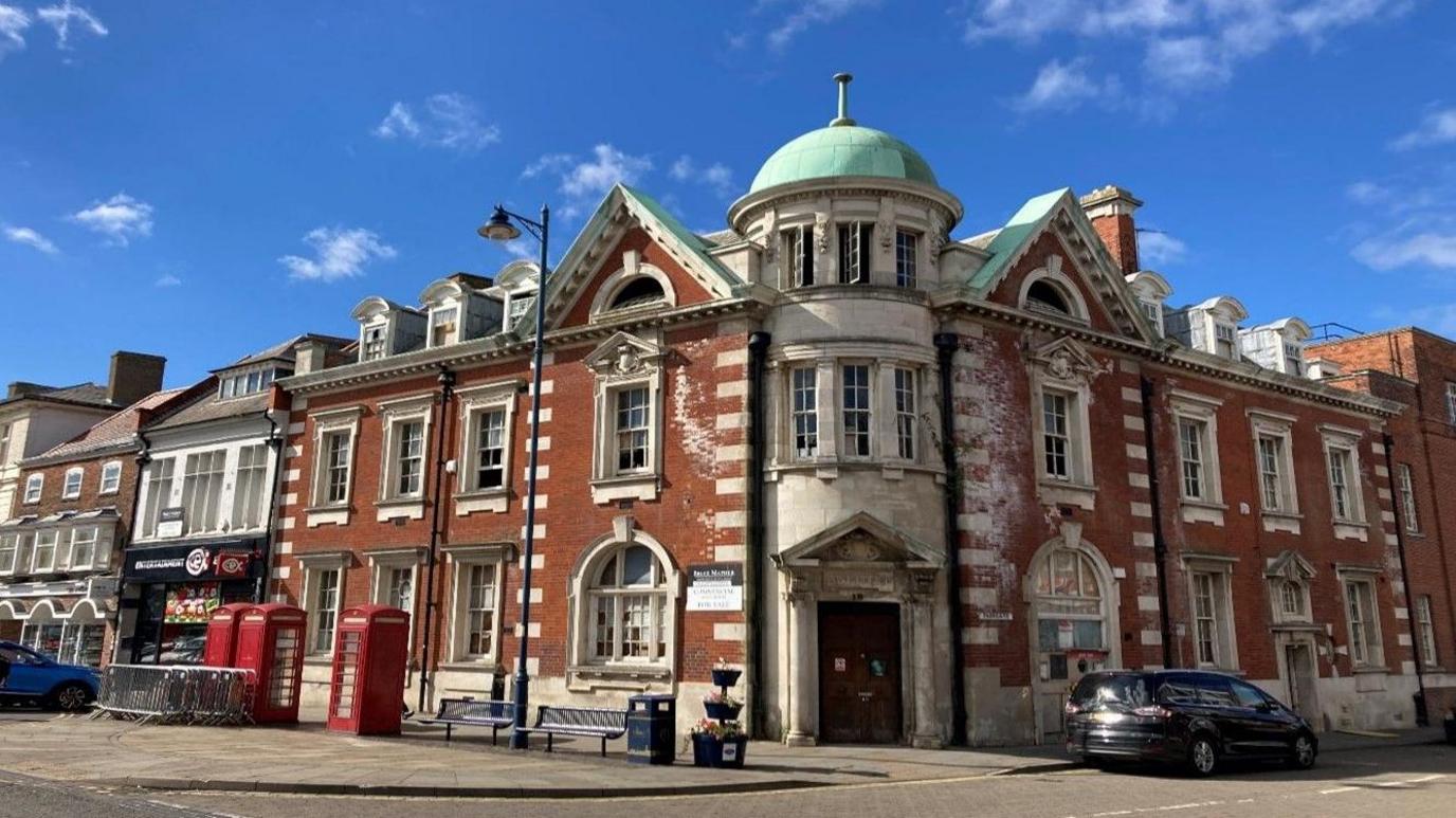 Former Post Office building in Boston town centre. The Grade II listed building has ornate window surrounds and a green domed roof over the entrance.