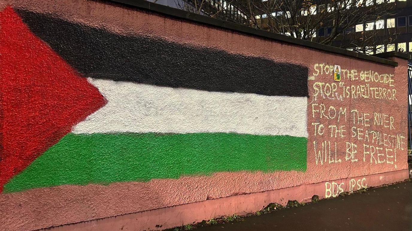 A wall at the royal victoria hospial in belfast  which has been daubed with the phrase “from the river to the sea, Palestine will be free”.  a Palestinian flag has also been painted on the wall