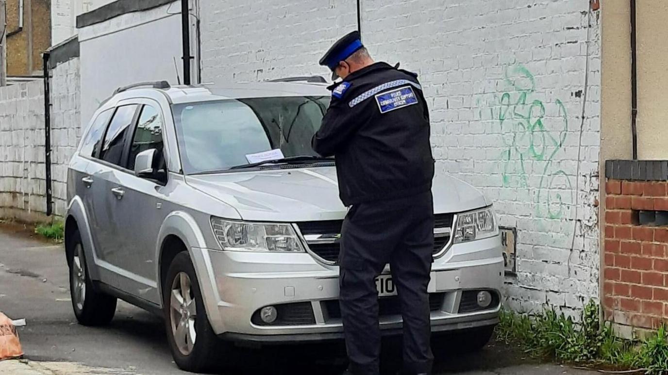 Police traffic officer near car