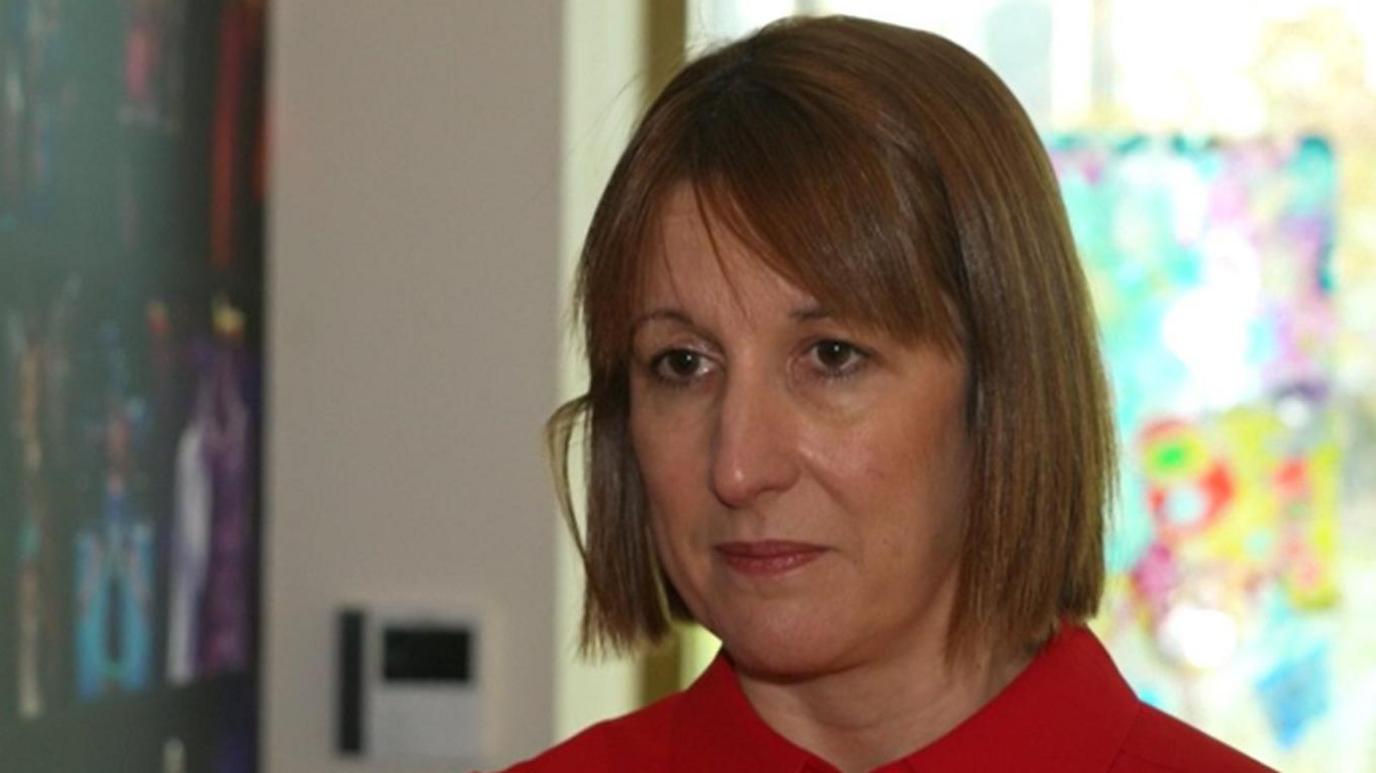 Rachel Reeves wears a red blouse and has chin-length brown hair and a fringe.