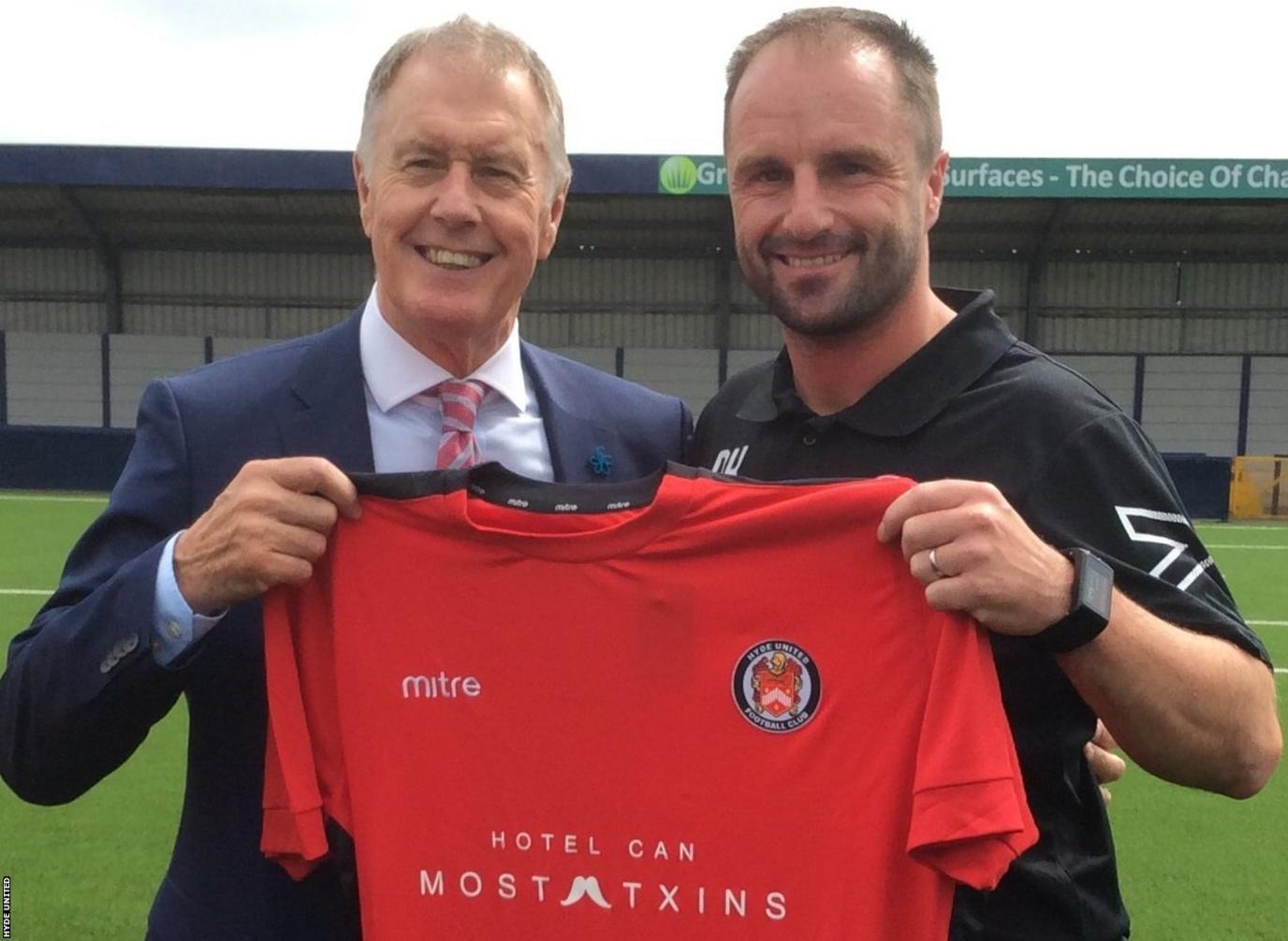 England World Cup hero Sir Geoff Hurst is presented with a Hyde United shirt by Tigers boss Darren Kelly