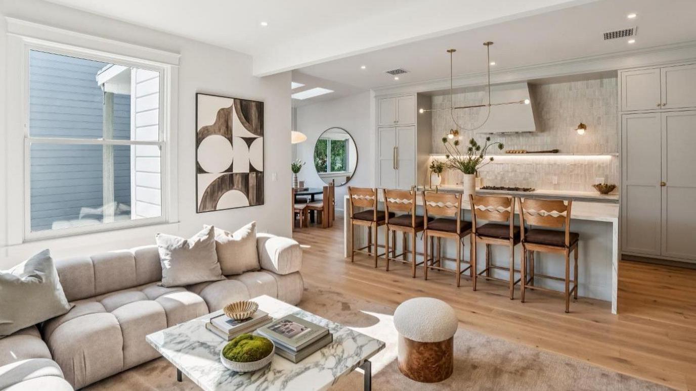 The lounge and dining area of the apartment in San Francisco, with a sofa area and dining tables