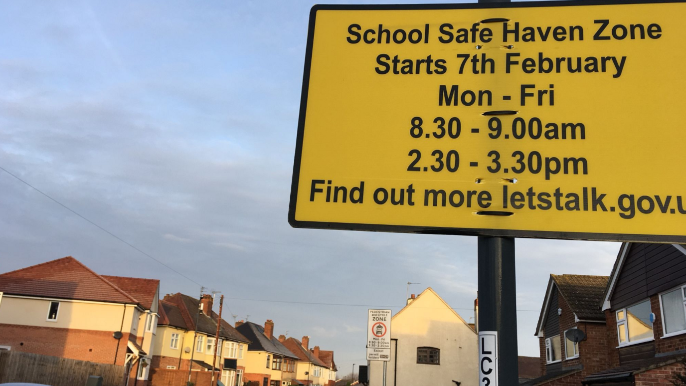 A yellow school zone sign