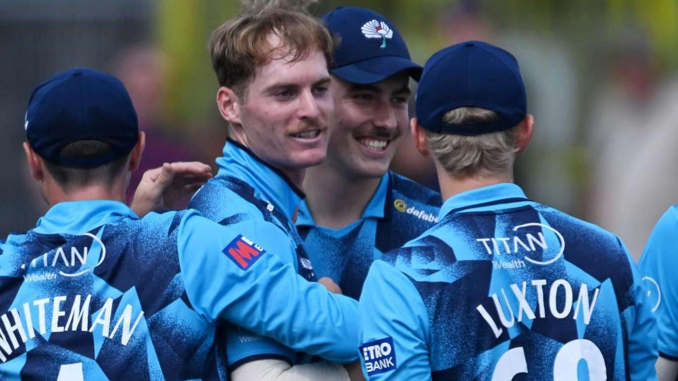 Ben Cliff (second from left) celebrates with team-mates