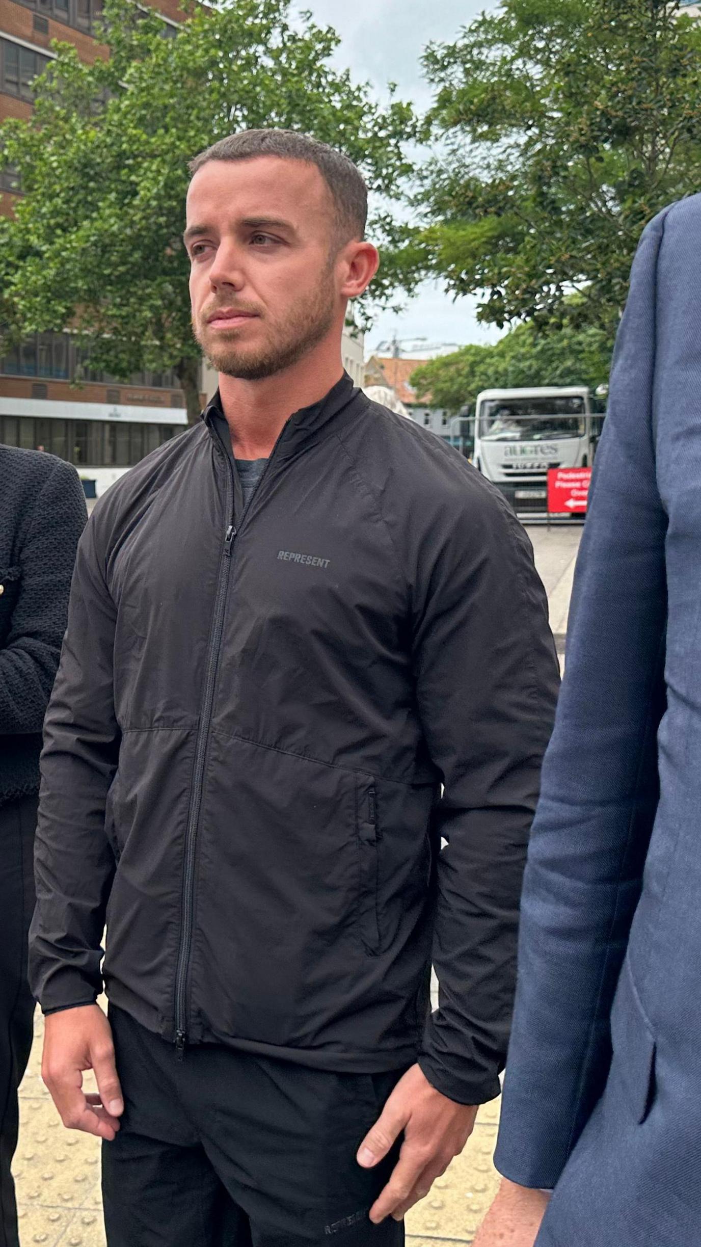 Lewis Peter Carr outside court, wearing a black jacket