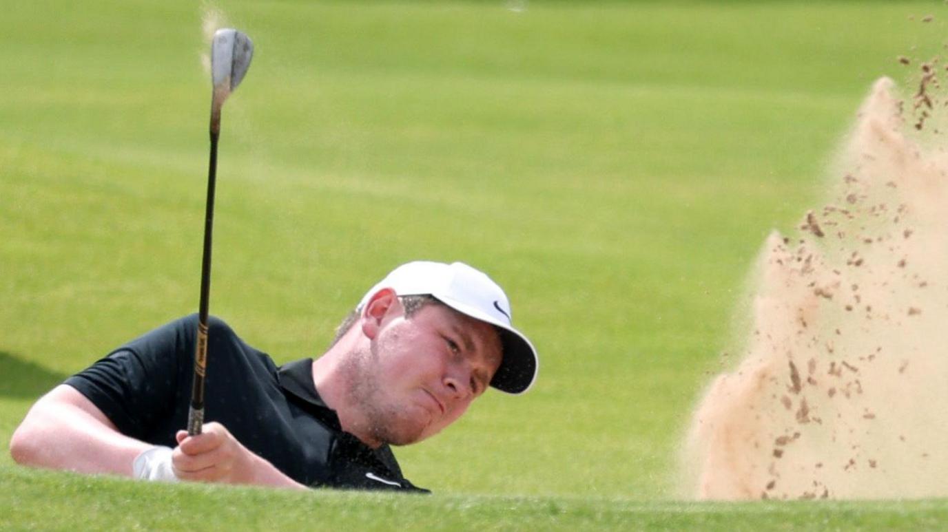 Bob MacIntyre plays a shot out of a bunker