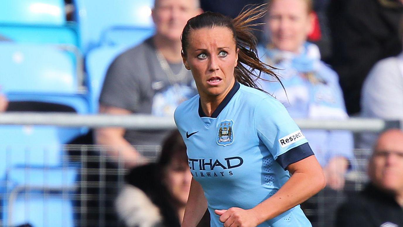 Natasha Harding, wearing a sky blue Manchester City top, runs during a match