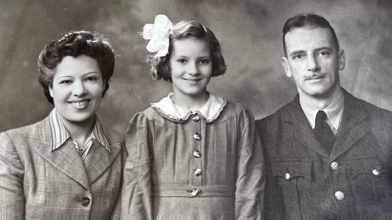 A black and white picture of Ann Mathers with parents Nena and Arthur "Jay" Jenkins taken in the 1940s.