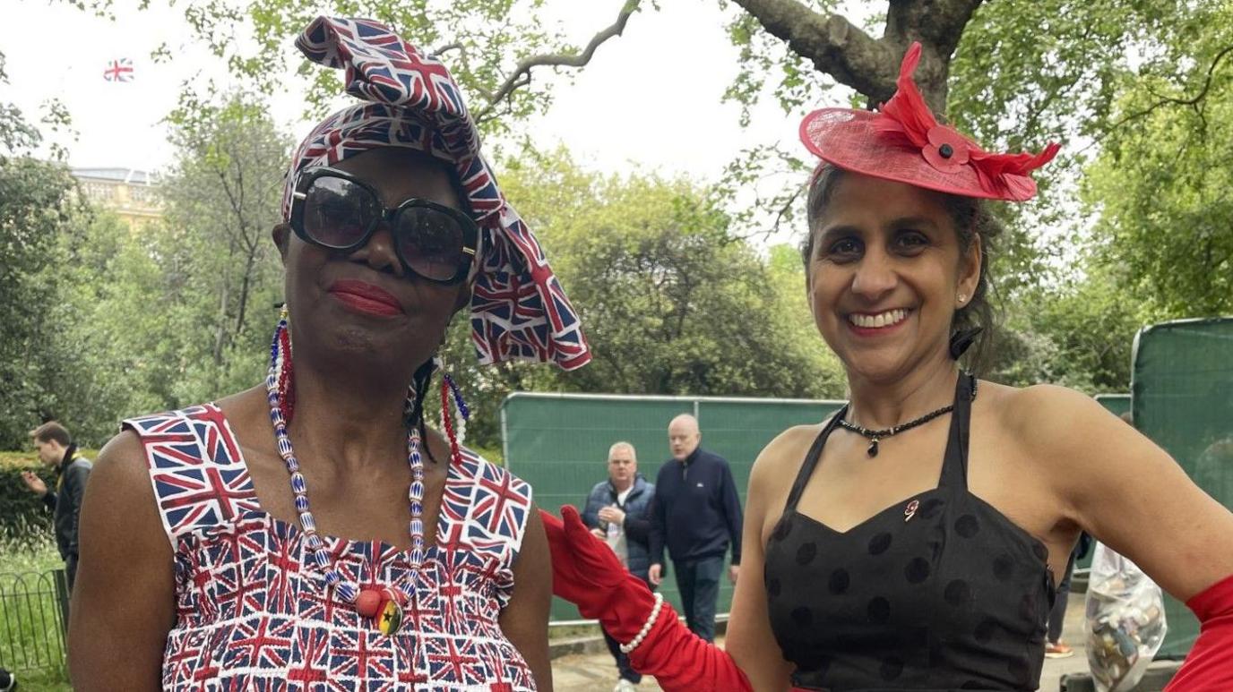 Two women are decked out in Union Jack memorabilia