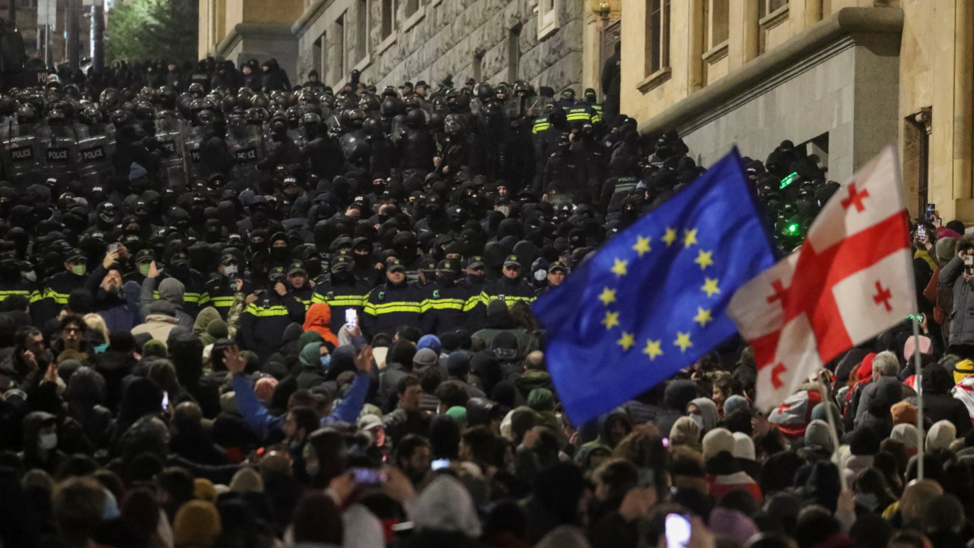 Supporters of Georgia's opposition attend a rally to protest after the government halted the EU application until 2028, as police officers block a street near the Parliament building, in Tbilisi