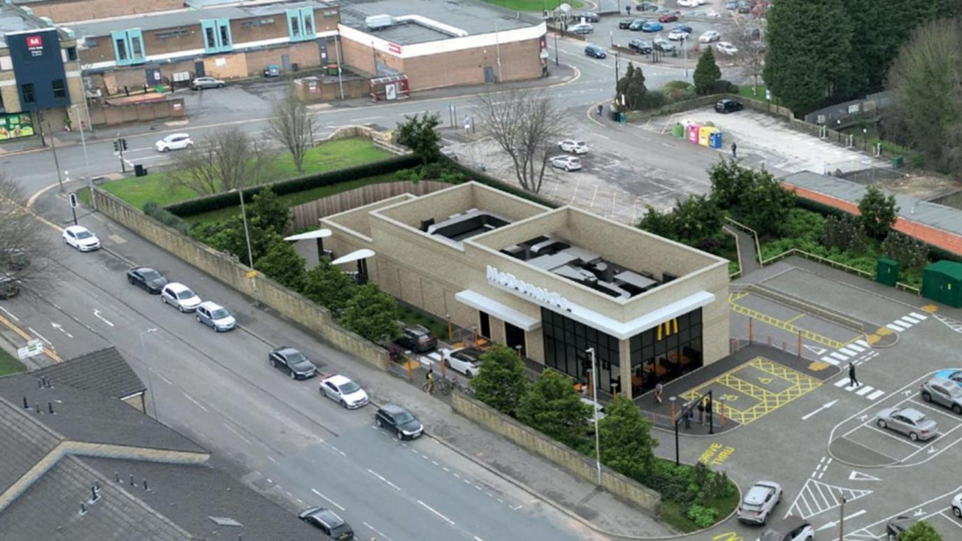 An artist's impression of how the McDonald's in Bingley could look, with a restaurant building superimposed onto a photograph of the area with a car park and streets around it