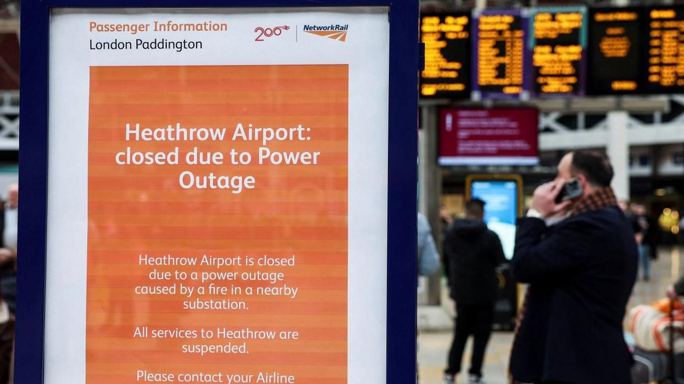 orange billboard with notice about heathrow outage