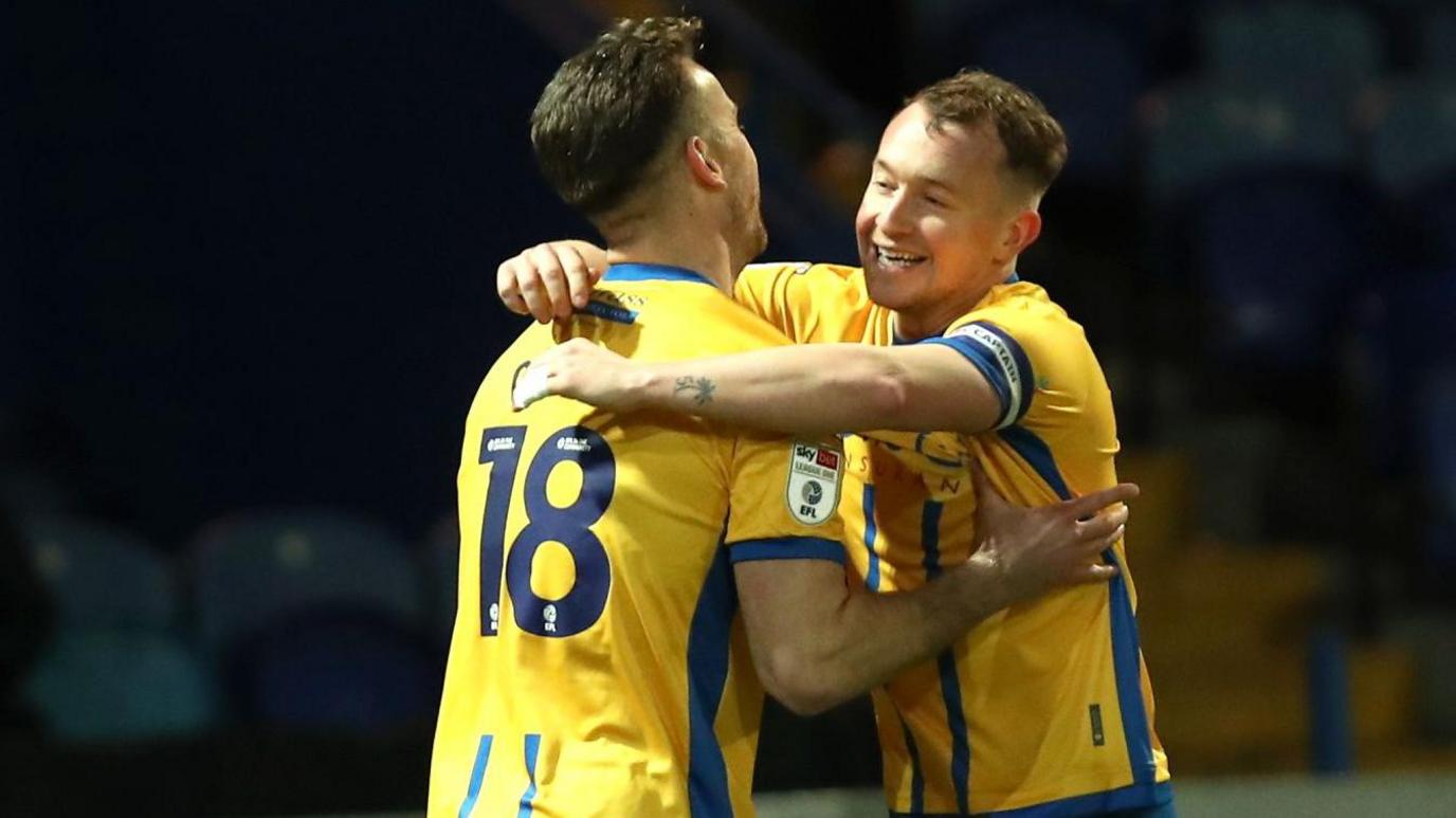 Louis Reed (right) is hugged by team-mate Rhys Oates