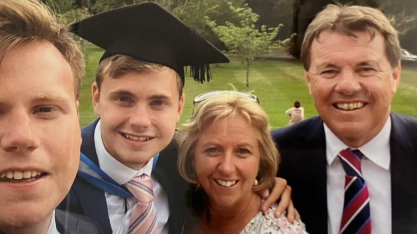 The O'Sullivan family at Jack's graduation with his arm around his mother, surrounded by his father and brother. Jack is wearing a mortar board