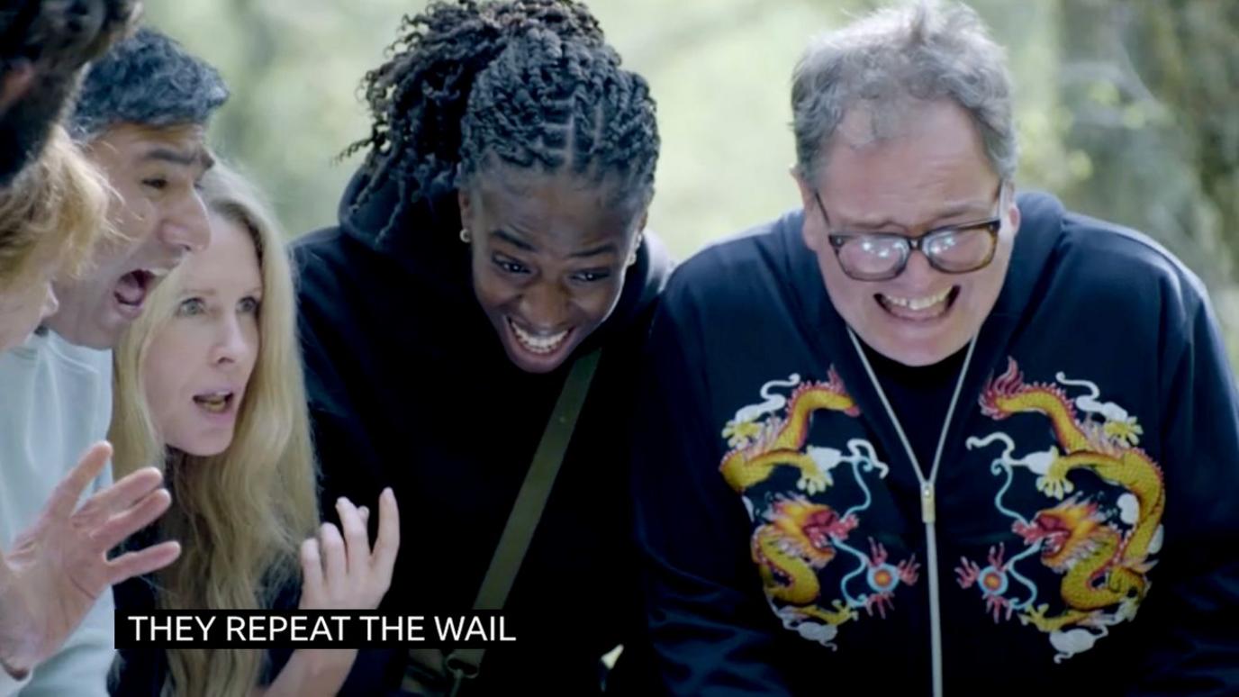 A scene from Celebrity Traitors around a well, where four of the players are pictured wailing while some of them laugh, they are outside in a forest.