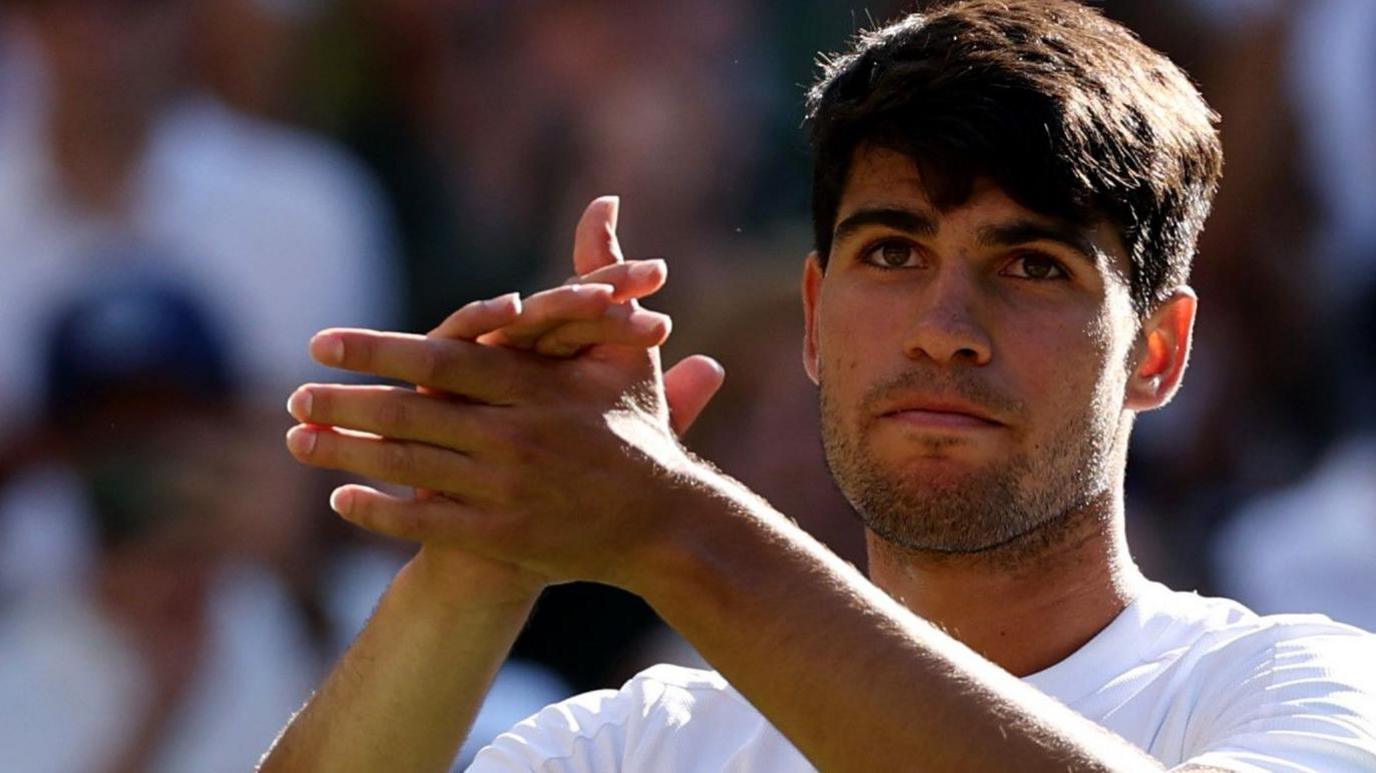 Carlos Alcaraz applauds the crowd on Centre Court after his victory over Oliver Tarvet on Wednesday