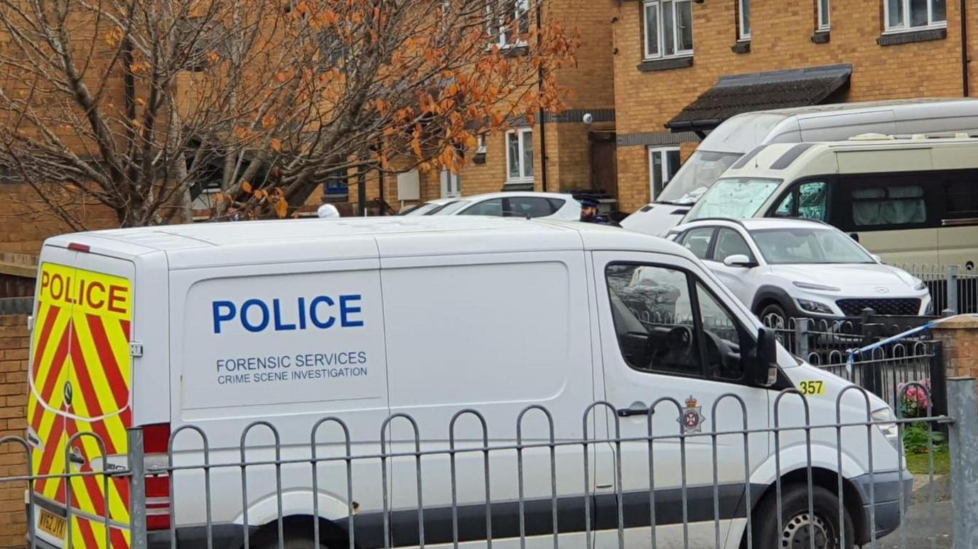 A forensic police van parked in a residential area