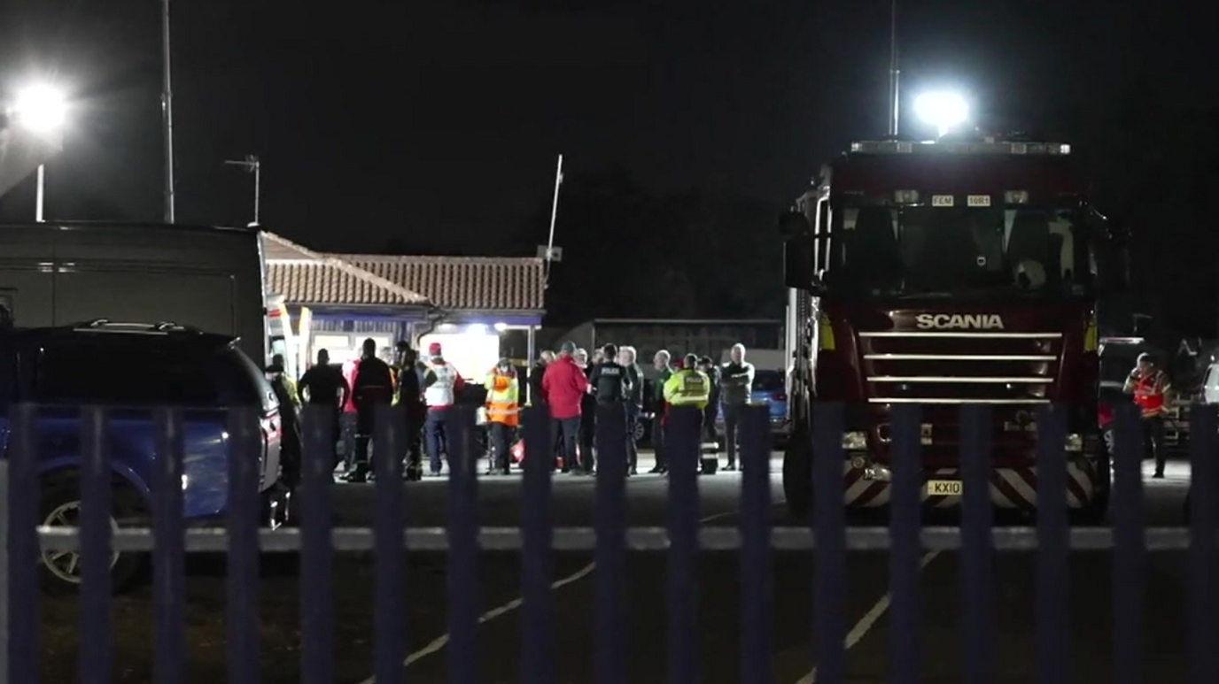 People gathering next to a fire service truck