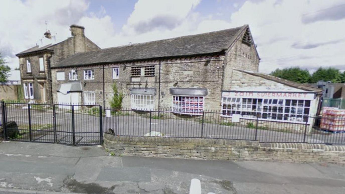 A listed building which is a farmhouse from the 1770s converted into a supermarket. This is an old photo which shows its original features.