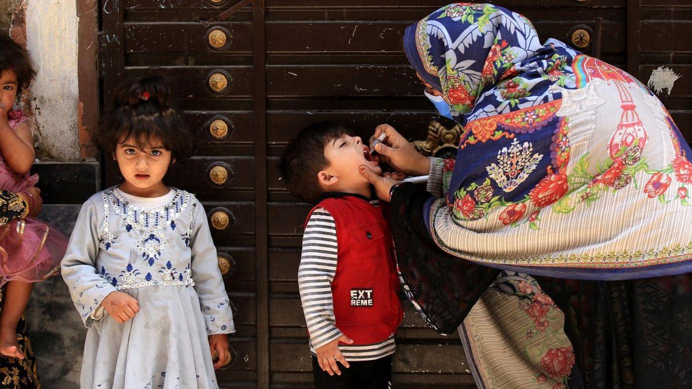 child getting polio drops in Kabul