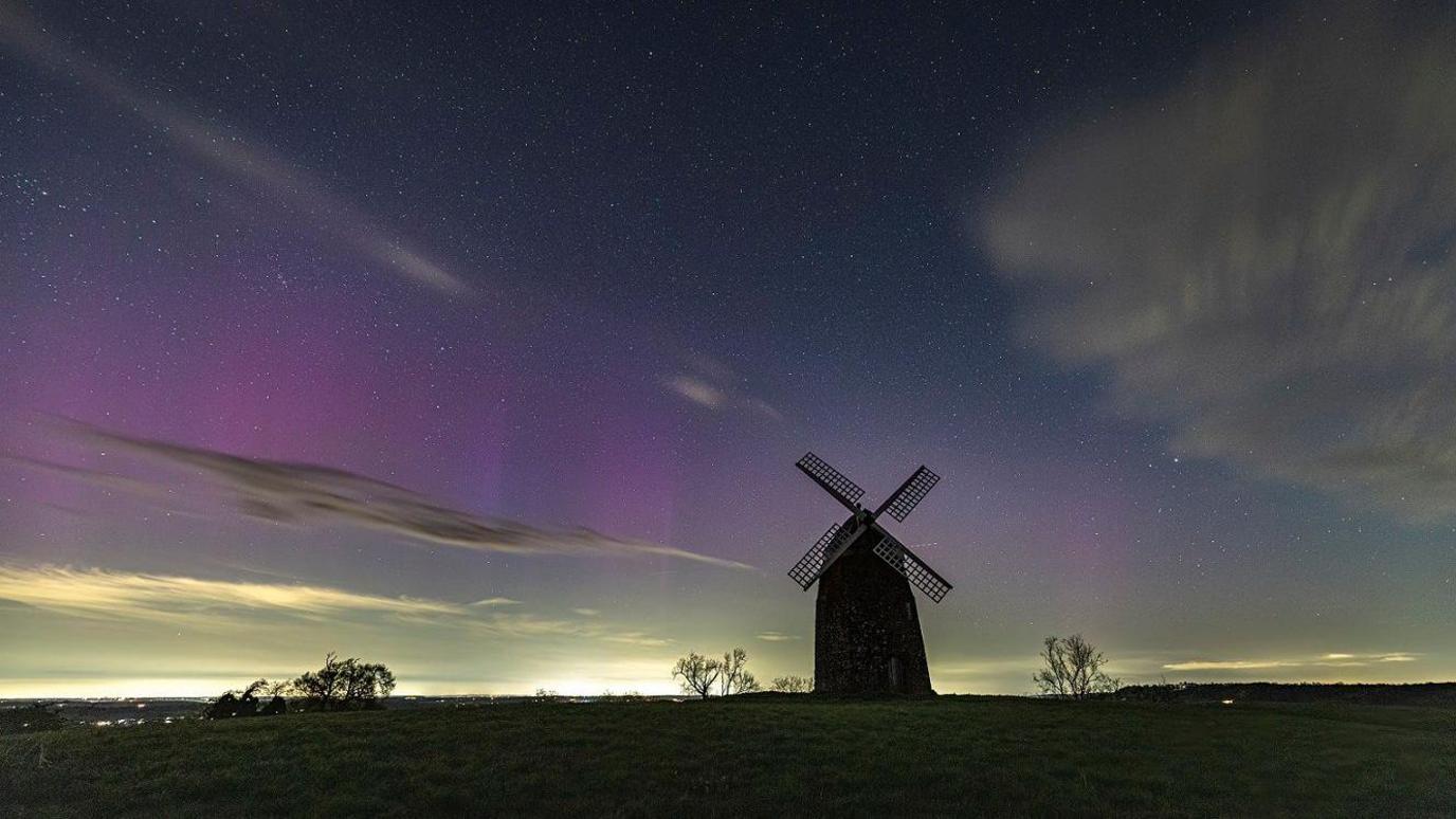 The aurora is seen in green and purple over Tysoe Windmill in the Cotswolds.