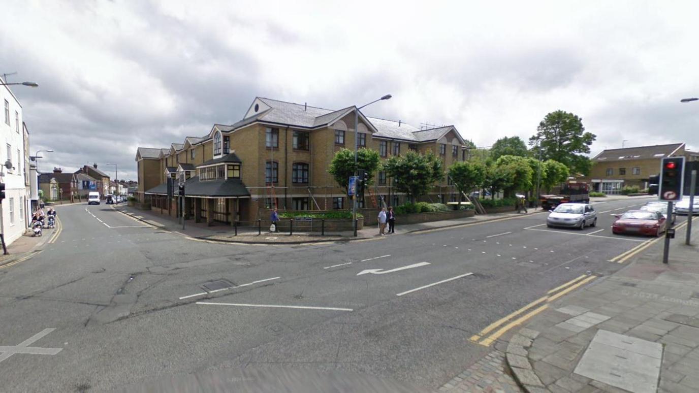 A Google street view of East Street. A number of cars are visible to the right of the image and a few pedestrians in the middle. 