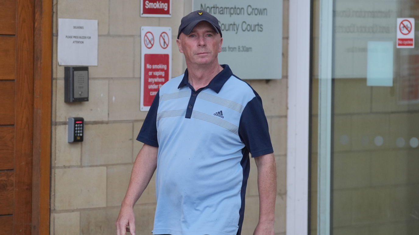 Raymond Connelly outside court in a blue adidas top and baseball hat