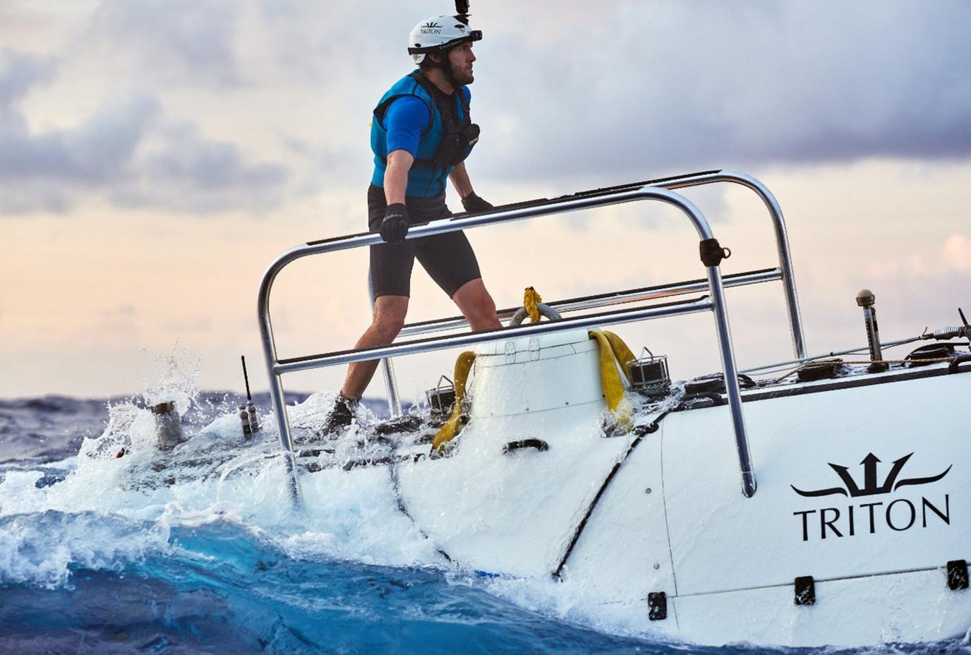 A member of the diving team stands on top of DSV Limiting Factor submersible