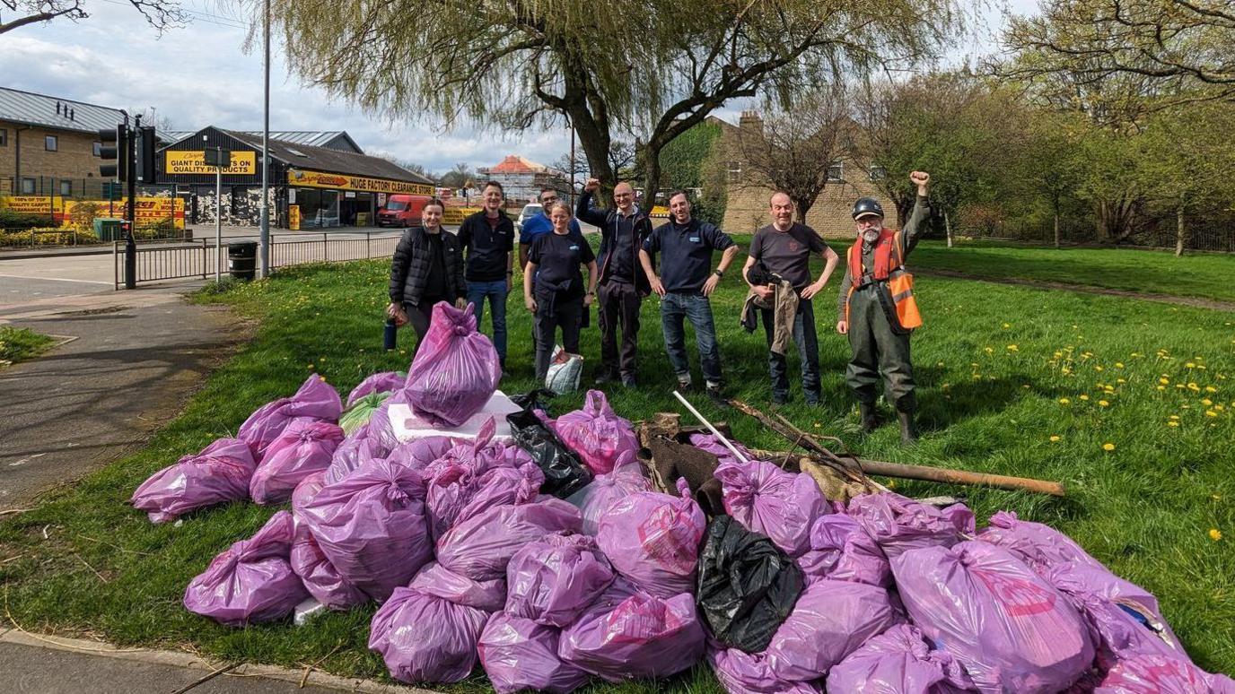 Volunteers with bags of rubbish