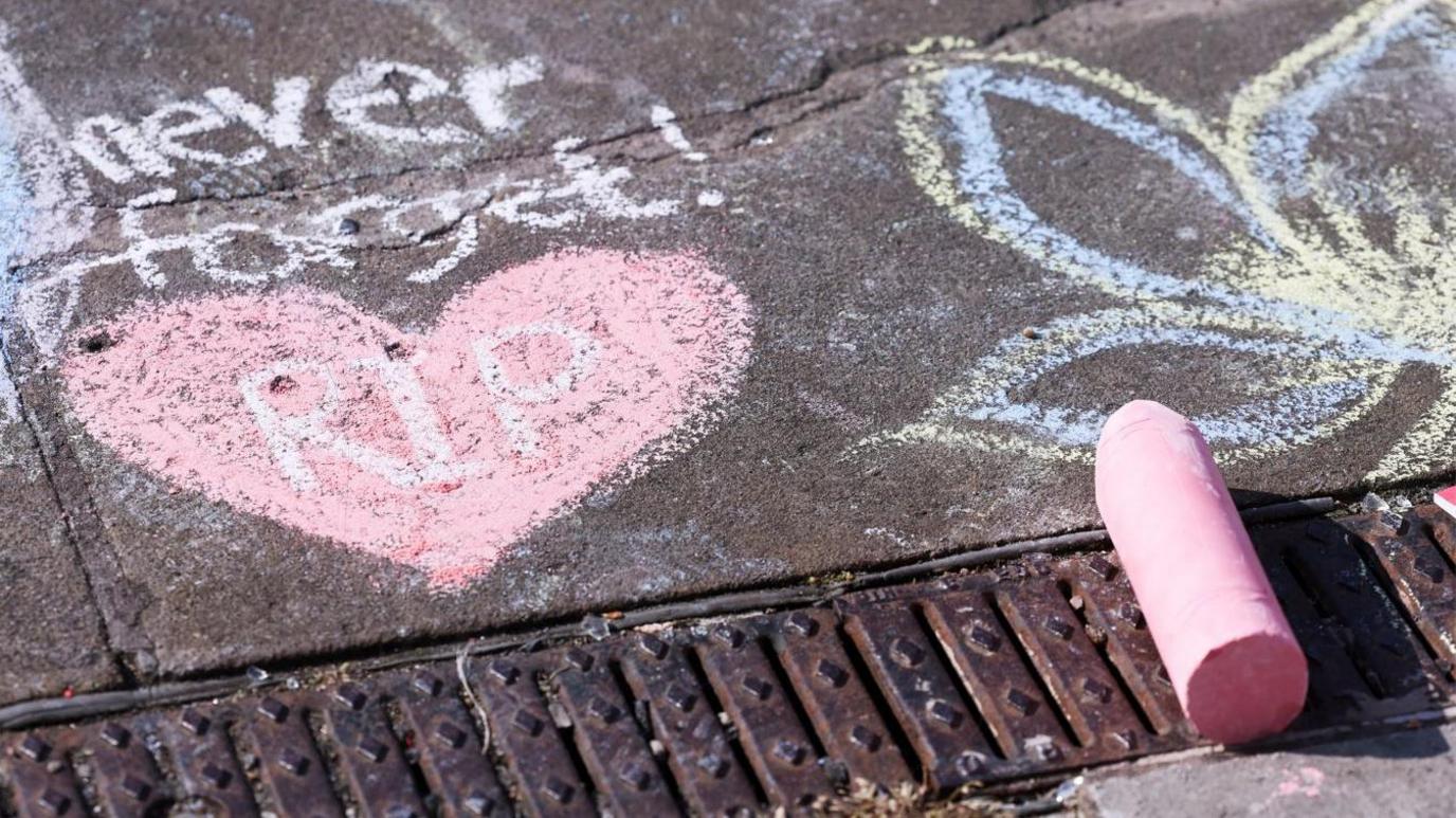 A chalk drawing in the ground in memory of Elsie Dot Stancombe, Bebe King and Alice Dasilva Aguiar, three children victims of a knife attack during a dance event in Southport,