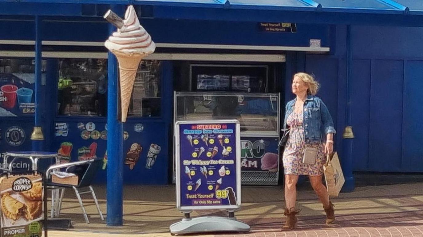 Page, dressed as Stacey, pictured walking near Marco's cafe in Barry