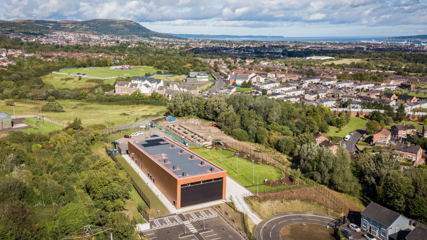 An aerial view of the Black Mountain Shared Space building in west Belfast. The surrounding area of west Belfast is visible in the image. 