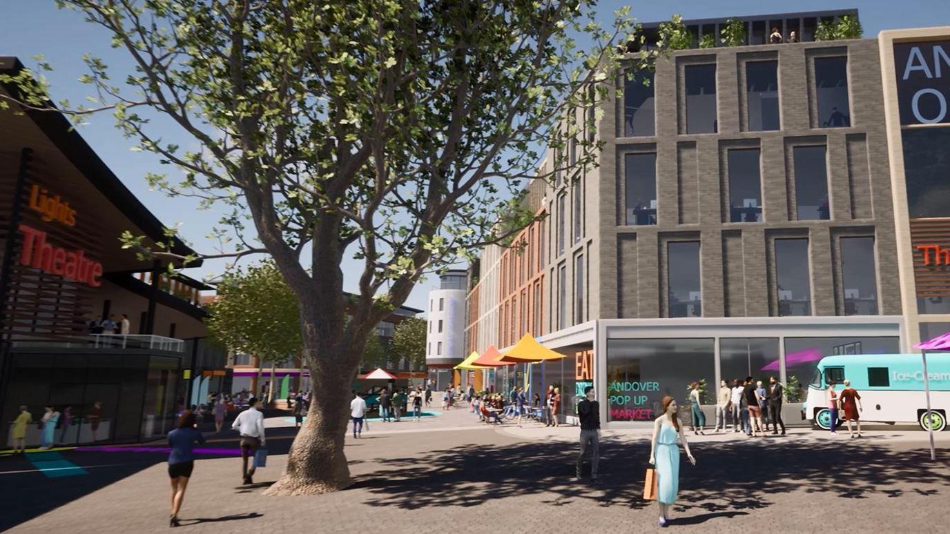 A prototype image of the new theatre in Andover. People are walking around on a sunny day in front of the building that spells Lights Theatre in yellow and red letters. People are queuing in front of the building. On the opposite side, people are sitting at tables outside an eating place. A blue and white ice cream van is parked nearby and a group of people is standing in front of it.