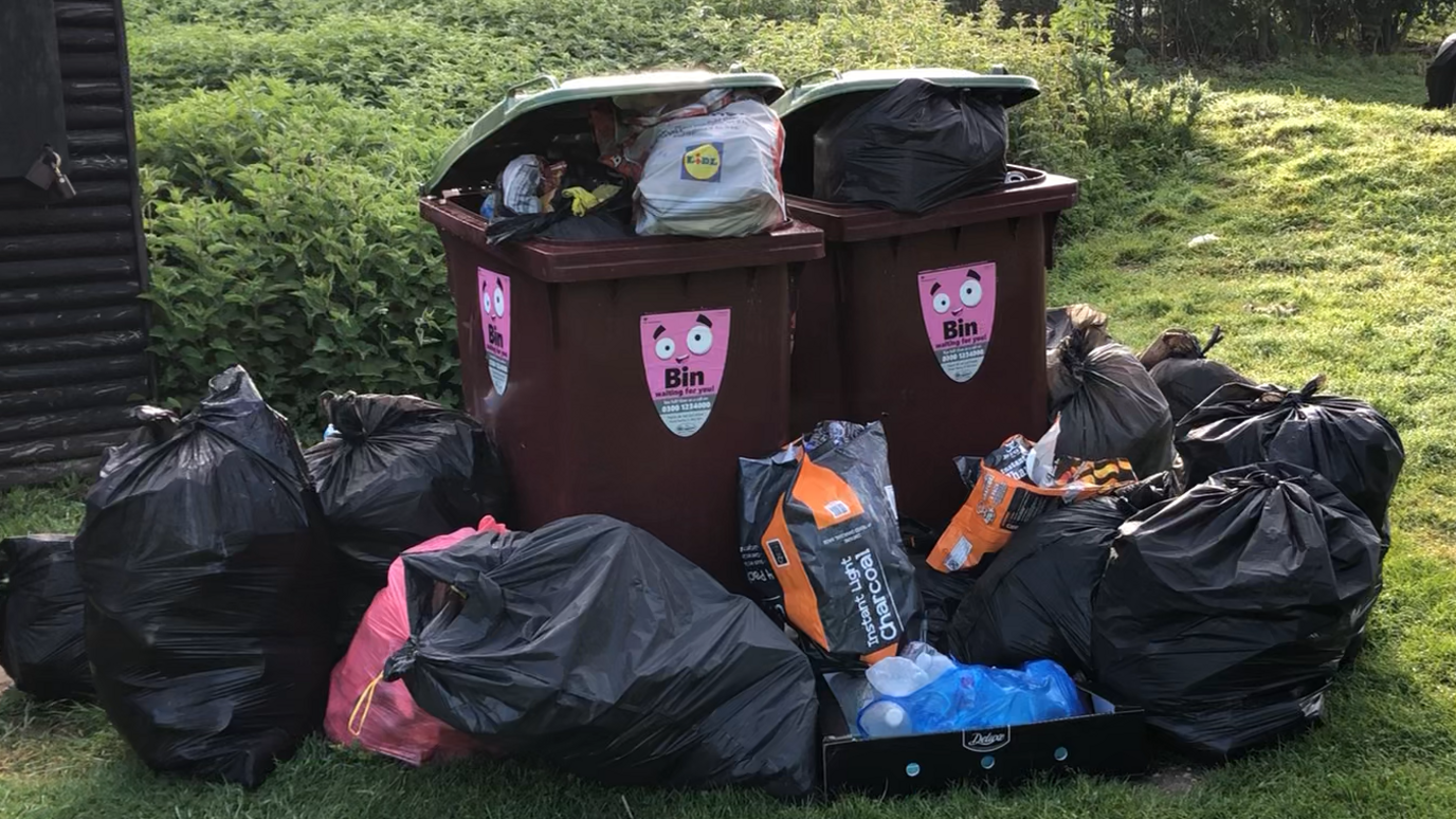 Rubbish left near a bin at Needham Lakes