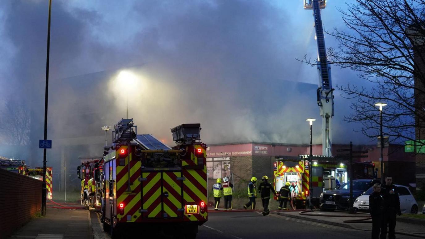 Firefighters at the scene of the fire on Raby Road