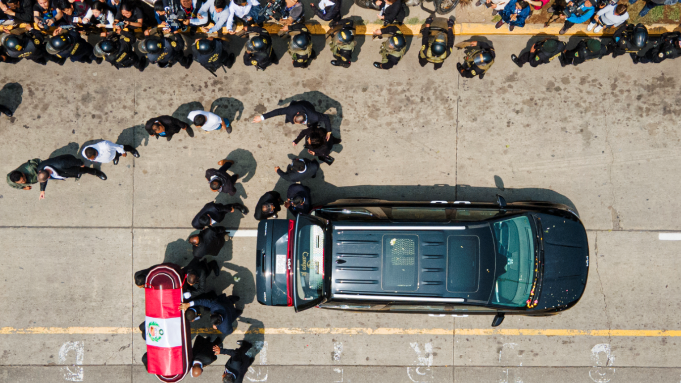 An aerial shot shows Fujimori's coffin, draped in a Peruvian national flag, being taken out of the hearse