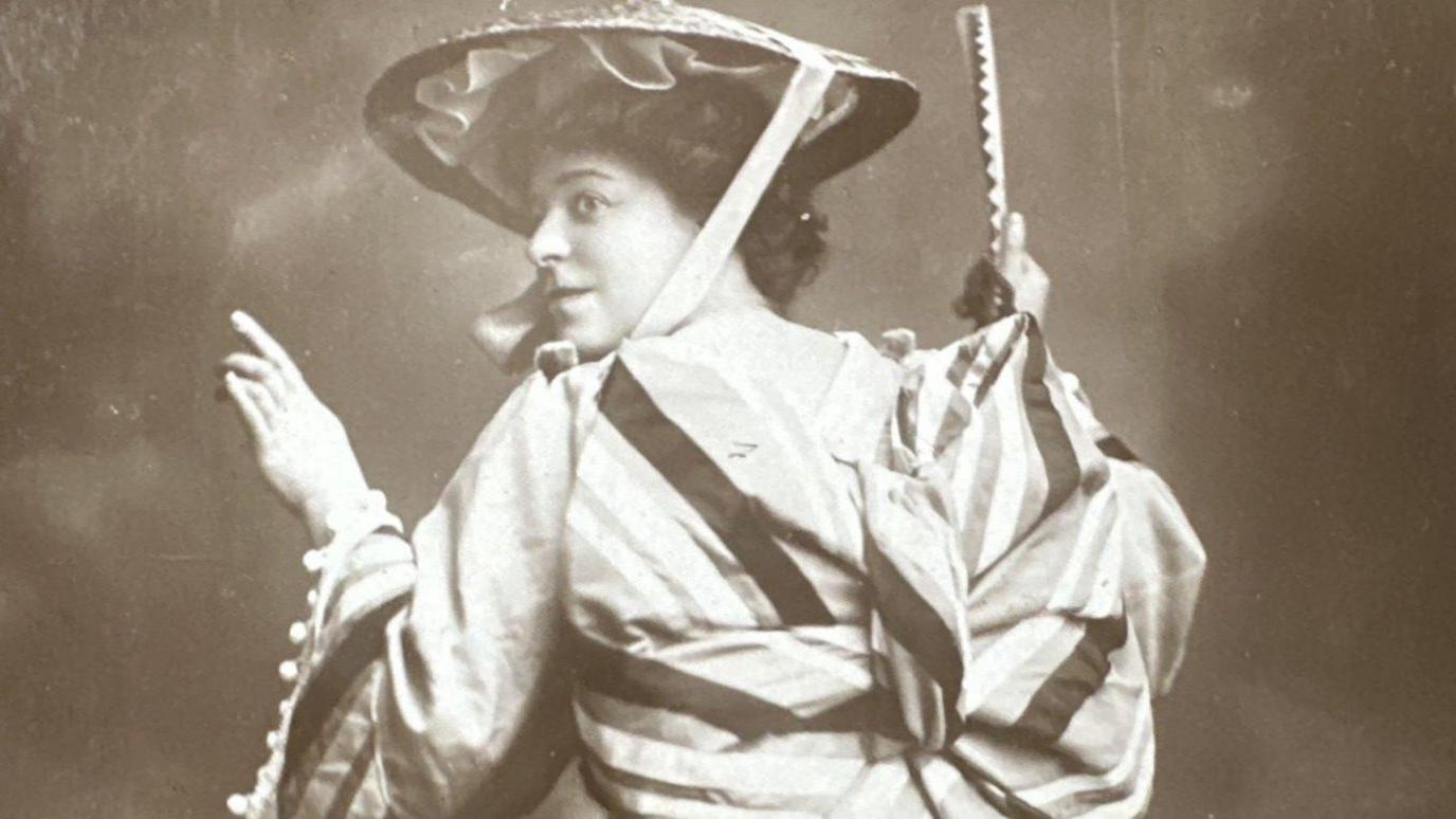Sepia-toned image of Ada Blanche wearing period dress.