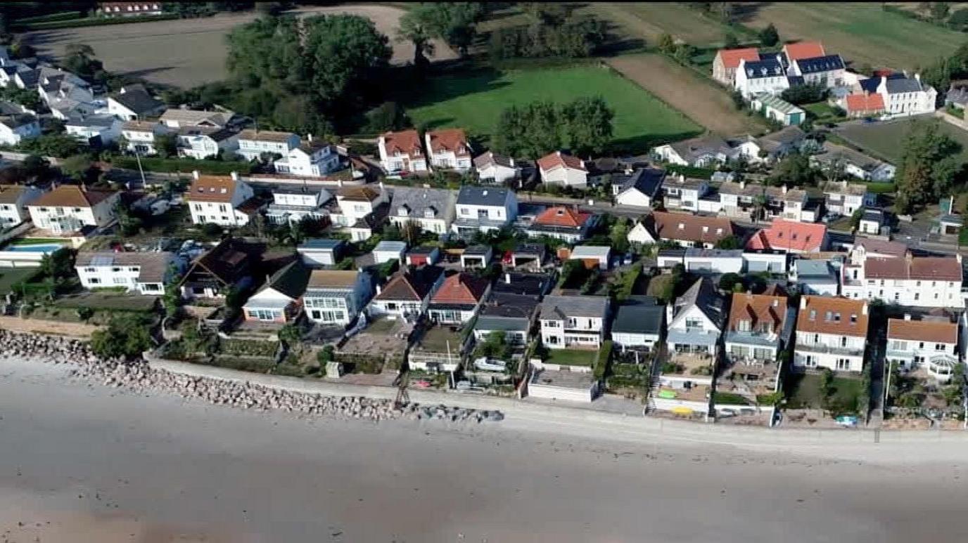 Aerial of houses by a beach in Jersey