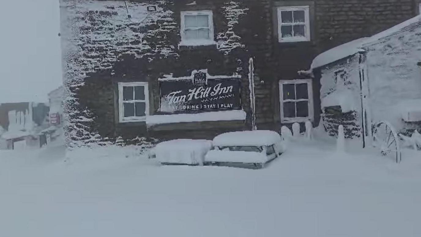 The front of the Tan Hill Inn covered in deep snow